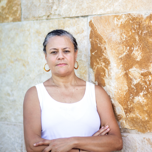 Prof Ater in front of stone wall smiling at camera